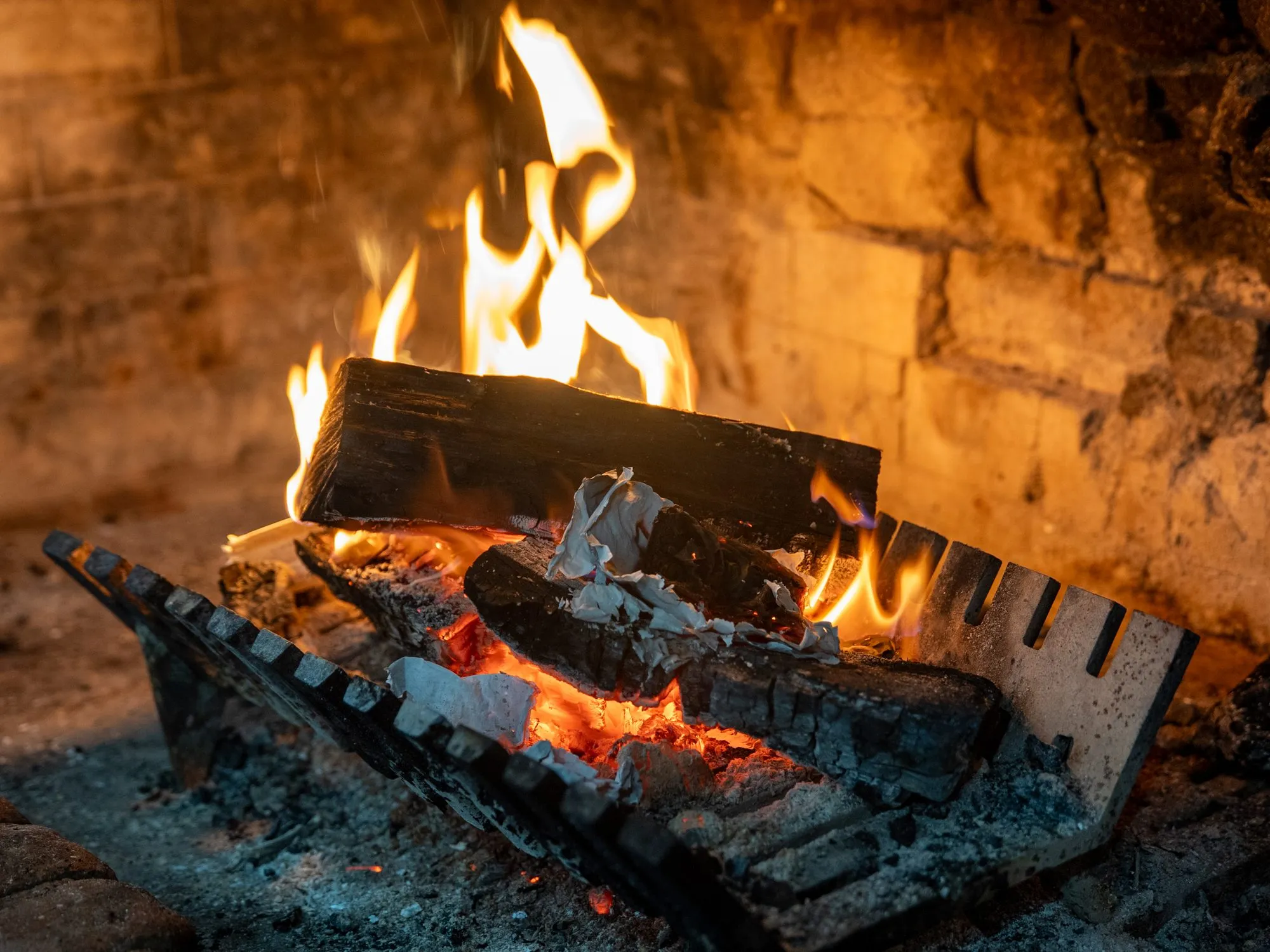 Logs burning in an open fireplace