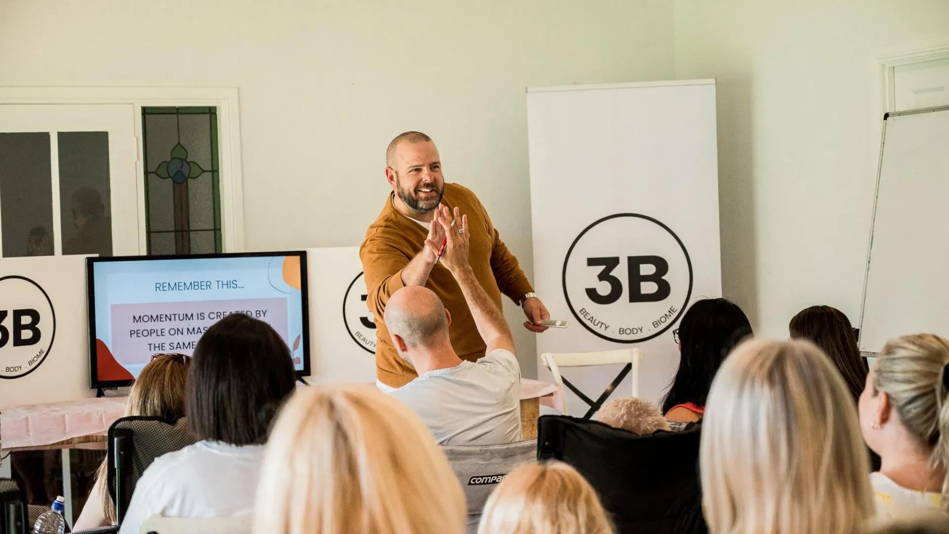 Brett smiling and high-fiving a participant during a small-group workshop