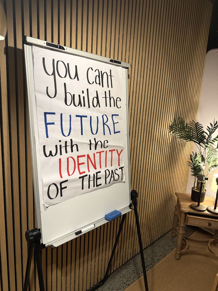 A flipchart that reads: You can't build the future with the identity of the past
