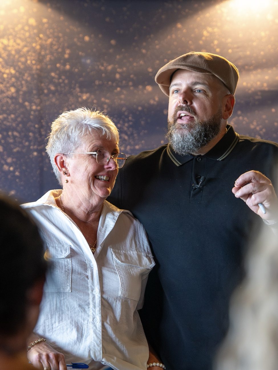 Brett Davis with a participant at a live workshop