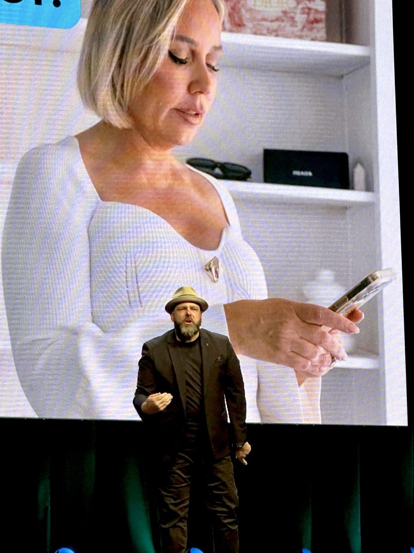Brett on stage with Sammie on the screen behind him