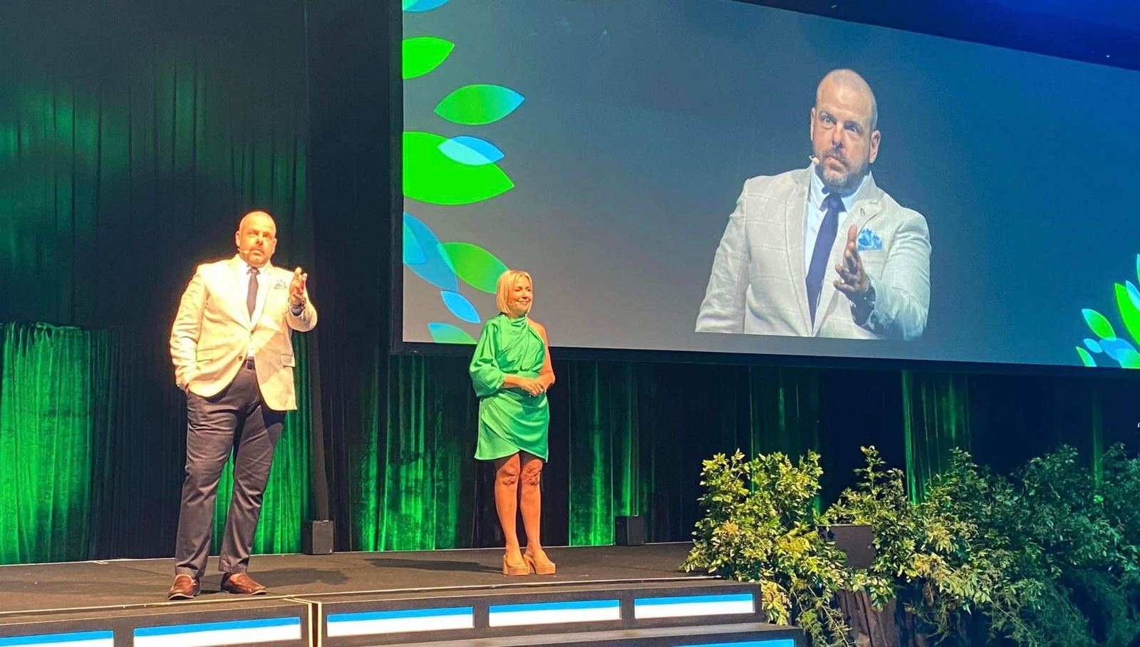 Brett Davis presenting on a large conference stage