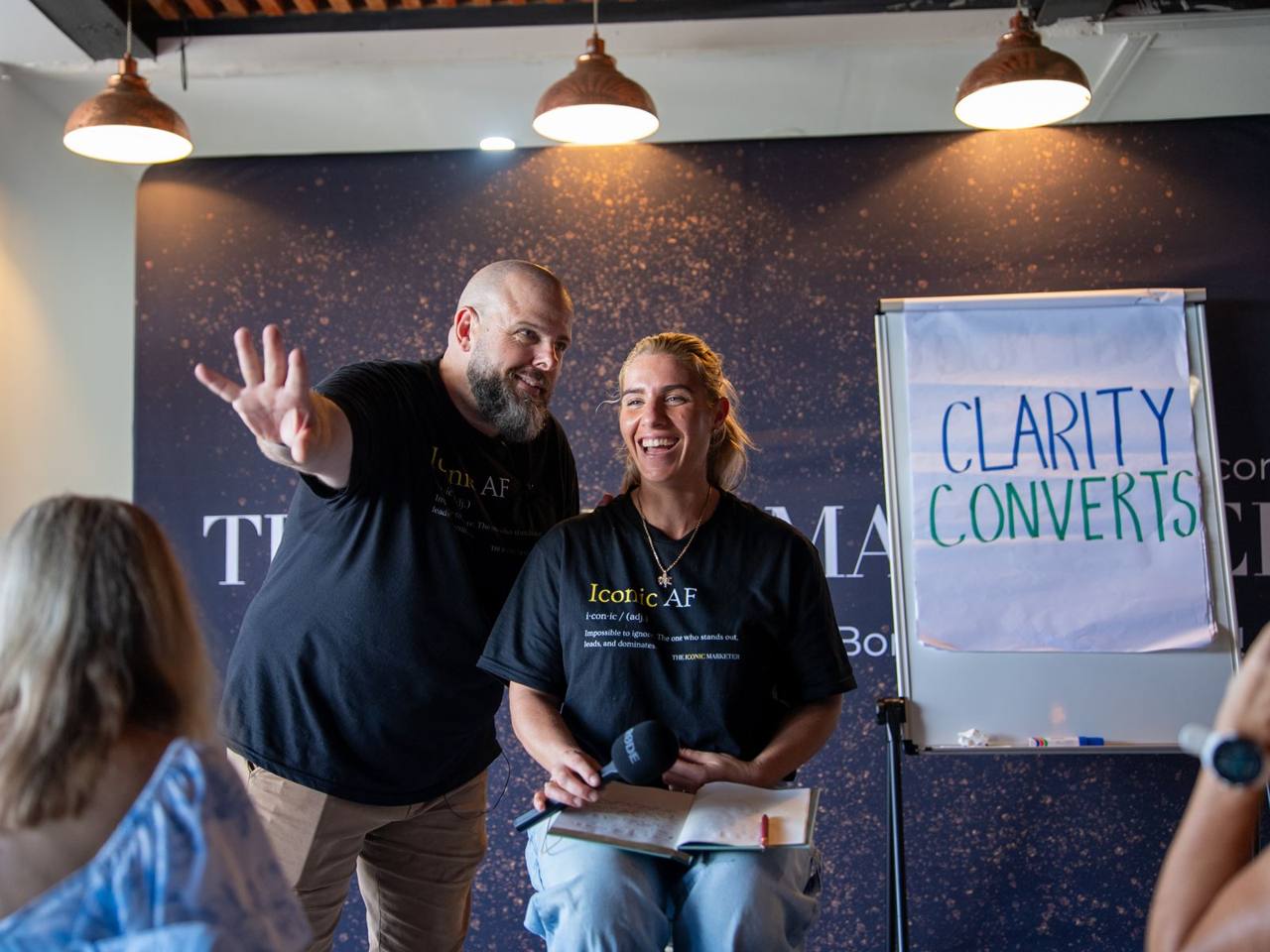 Brett Davis on stage with a participant