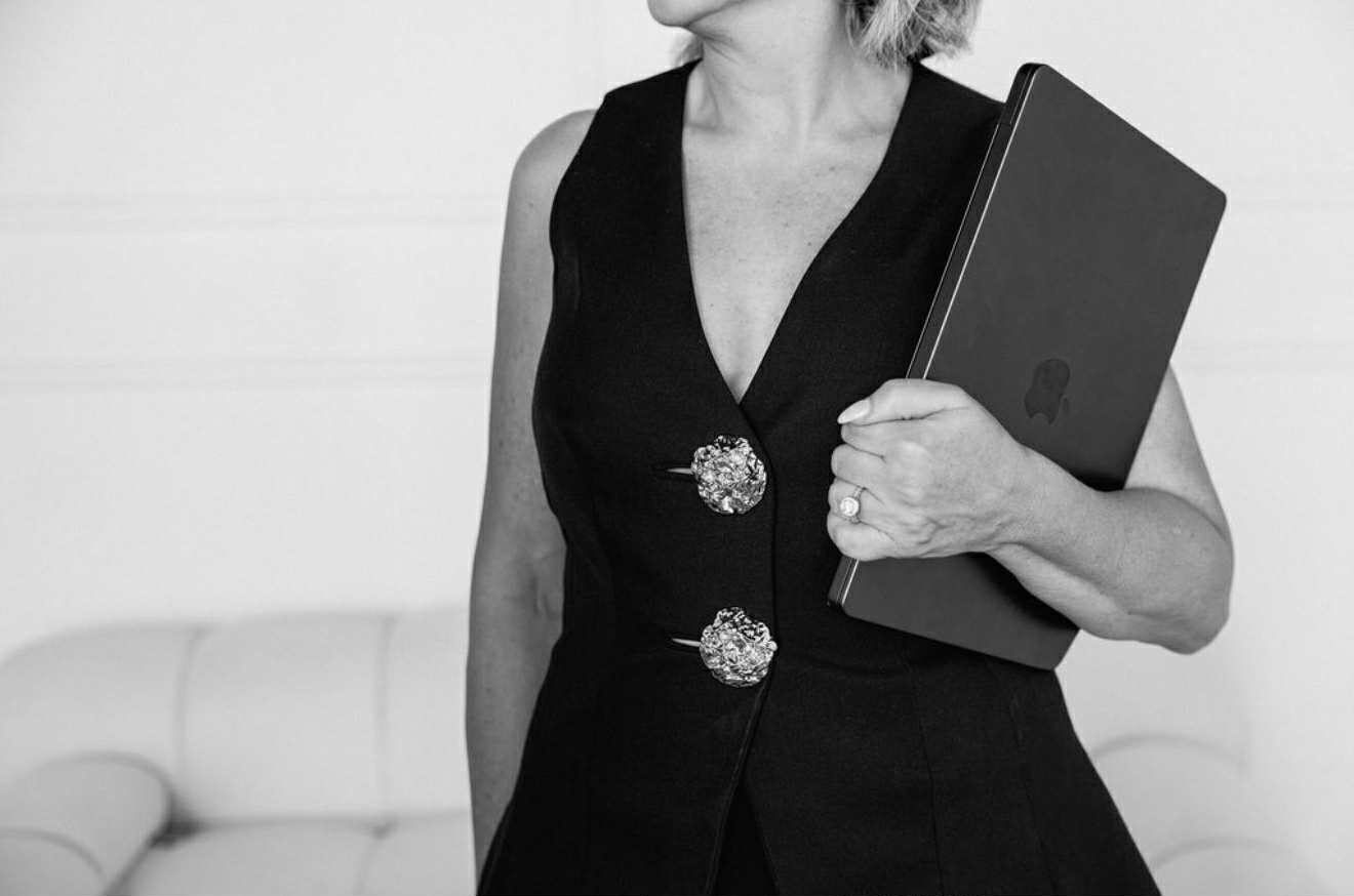 Sammie Gascoigne holding a laptop, in black and white